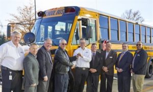 Caley Edglery hands keys over to Henrico School's new DD5 school bus.
