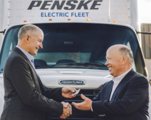 Roger Nielsen hands keys to Freightliner Electric truck to Brian Hard of Penske