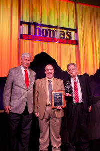 Chad Waller, Deputy Parts Manager, accepts the Gold Level Parts Award on behalf of Sonny Merryman.