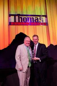 Floyd Merryman, President & CEO of Sonny Merryman accepting the Midwest Dealer of the Year Award from Caley Edgerly, President & CEO of Thomas Built Buses.